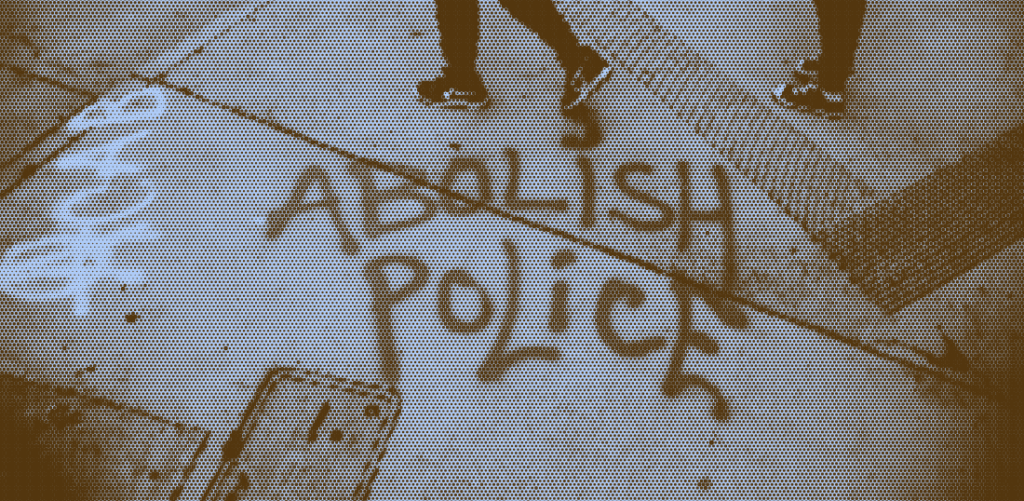 A spraypainted sidewalk that says "ACAB - Abolish Police"