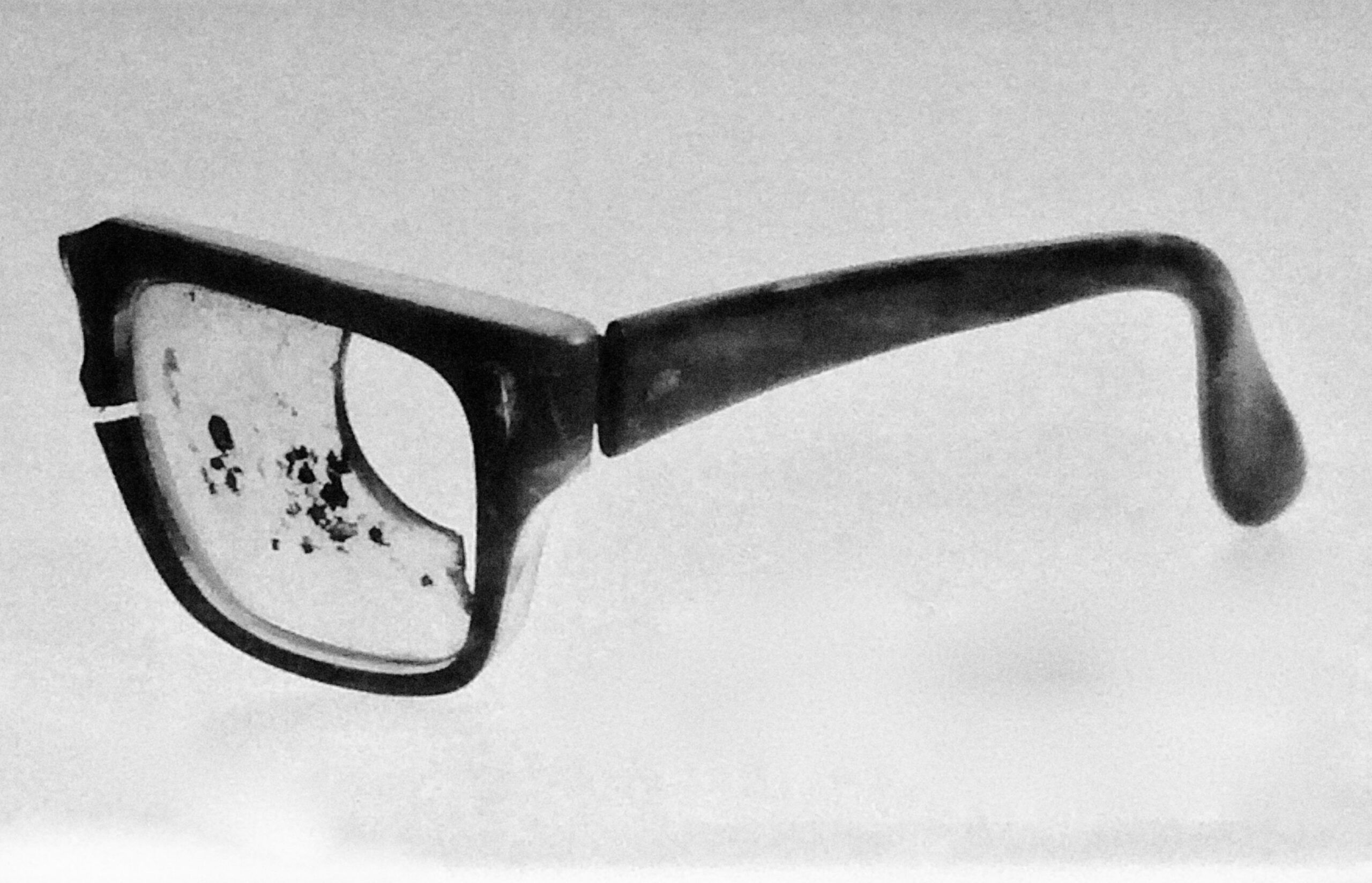 A black and white image of Chilean President Salvador Allende's glasses, damaged in the coup.