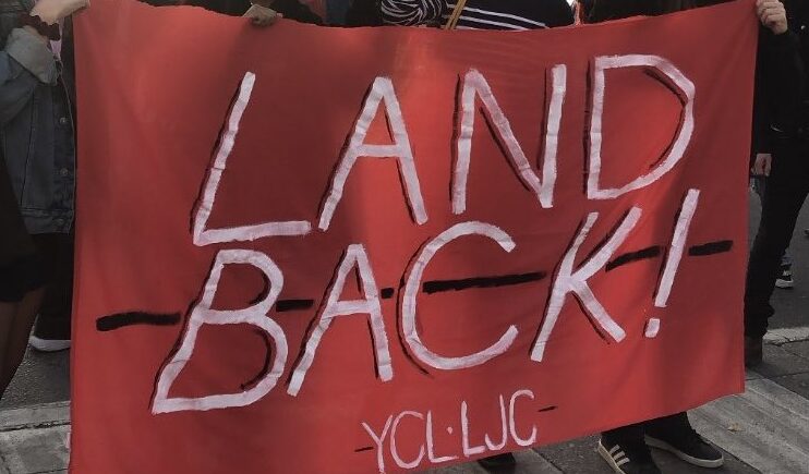 A red banner that says "Land back! YCL-LJC"