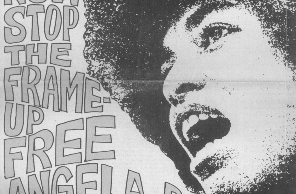 A black and white scan of a magazine cover featuring a photo of Angela Davis. It says "Stop the frame-up, Free Angela!" in large block letters, and features Angela Davis speaking into a microphone.