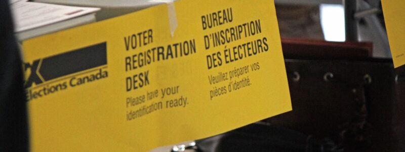 An image of a yellow Elections Canada voter registration sign.