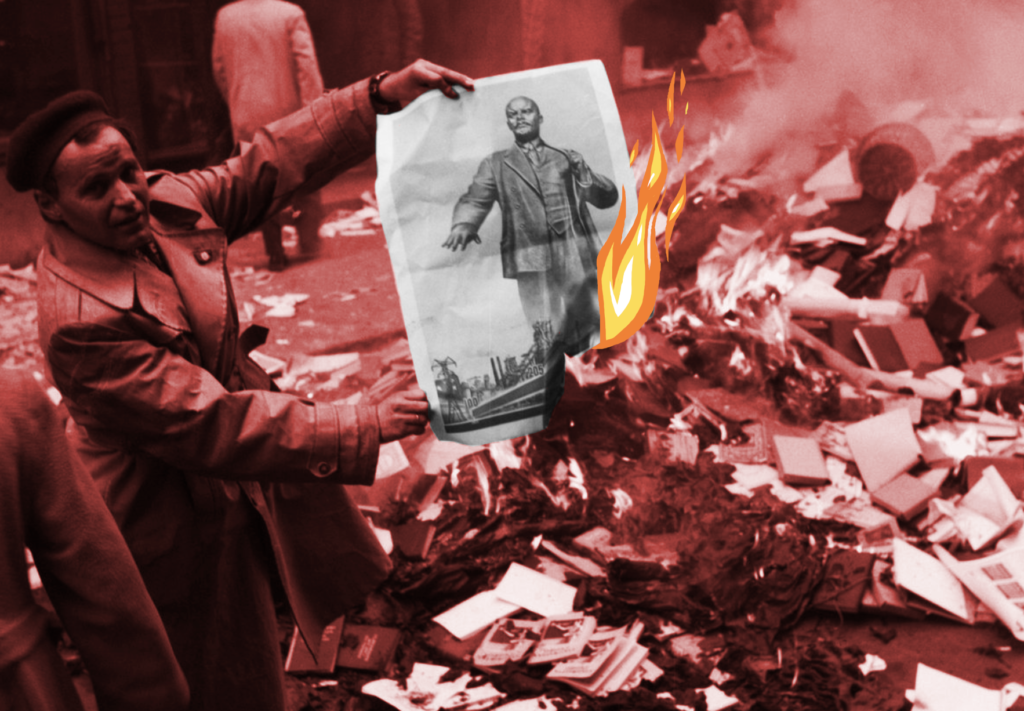 A photograph of a Hungarian man at a book burning in 1956. He holds up a picture of Vladimir Lenin, which is in flames. Behind him is a pile of books and pictures of Lenin that are actively burning. The photograph is washed with a red tint, except for Lenin, and there are flames drawn over the side of his picture.