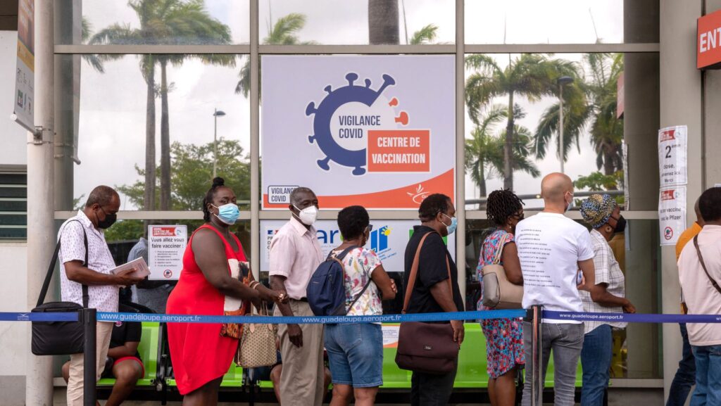 A photograph of people in Guadeloupe lining up to receive COVID-19 vaccinations